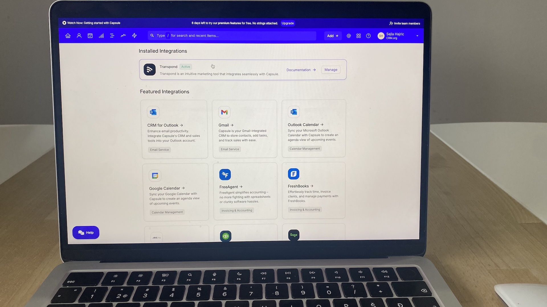 Capsule CRM integrations dashboard showing installed and featured apps like Gmail, Outlook, QuickBooks, and FreshBooks.