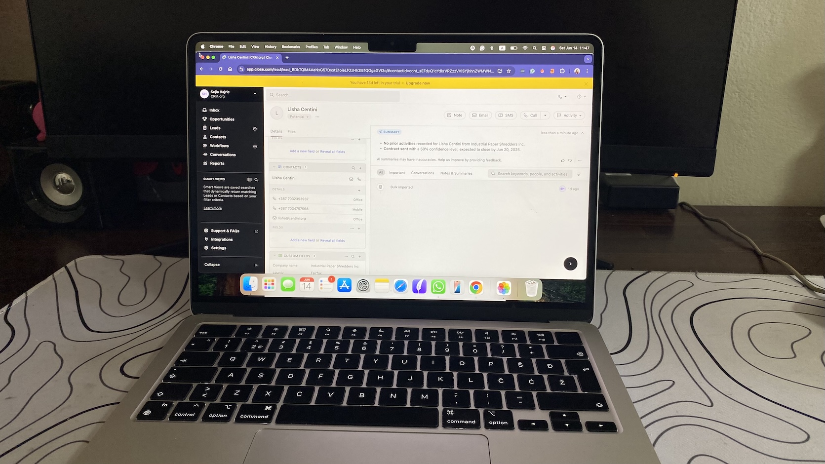 Laptop showing Close CRM lead profile with sidebar navigation and an AI-generated summary for a potential sales contact.
