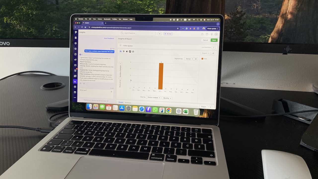 MacBook laptop displaying Pipedrive AI Insights sales report with an orange bar chart and text analysis