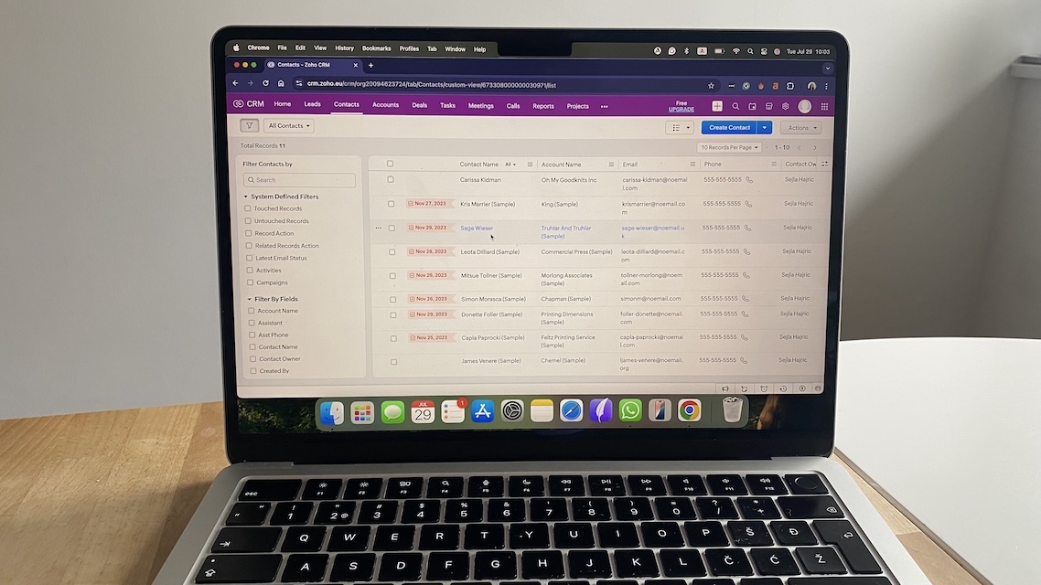 Zoho CRM contacts view showing filtered contact list with fields for account name, email, phone number, and contact owner.
