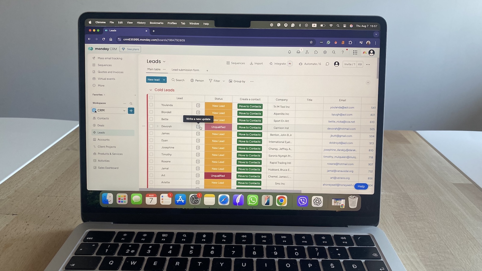 Monday CRM lead tracking board showing cold leads, status labels, company info, and option to convert leads to contacts.
